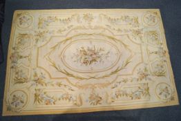 A 20th century Aubusson rug woven with garlands of flowers in a muted tones of blue,