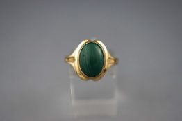 A Continental oval malachite cabochon single stone ring, probably German, stamped '333', size T+,