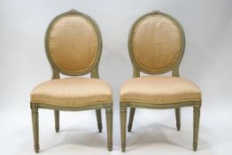 A pair of French style painted salon chairs with oval backs,