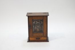 An Arts & Crafts oak smokers cabinet,