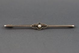 A yellow and white metal bar brooch set with a seed pearl and rose cut diamonds.