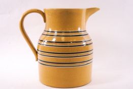 A large Victorian mocha wave jug with eight bands on a yellow ground. Height 22cm.