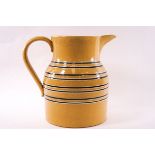 A large Victorian mocha wave jug with eight bands on a yellow ground. Height 22cm.