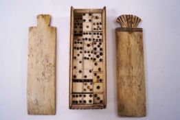 A late 18th century bone scrimshaw set of dominoes, the case with double sliding top, length 14cm.