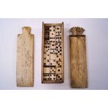 A late 18th century bone scrimshaw set of dominoes, the case with double sliding top, length 14cm.