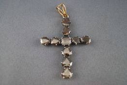 A diamond stylised Latin cross, set with ten 'fantasy-cut' brown-ish grey diamonds,