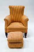 A 19th century armchair upholstered in a chequered material on turned legs,