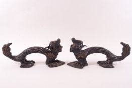 A pair of Chinese bronze door handles, modelled as mythical beasts,