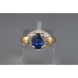 A 9ct gold, sapphire and diamond dress ring, centred with an oval native-cut sapphire approx. 2.