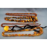 A quantity of amber and imitation-amber necklaces; comprising; an opaque,