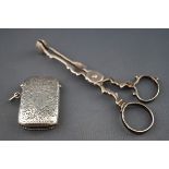 A silver vesta/match case engraved with foliate scrolls and a script initial F,