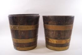 A pair of brass bound oak wine coolers with tin liners,