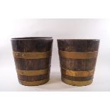 A pair of brass bound oak wine coolers with tin liners,