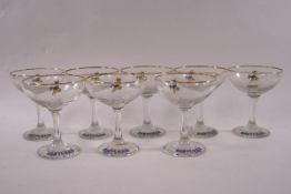 A composite set of eight Babycham champagne glasses, each with gilt rims.