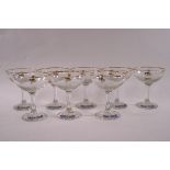 A composite set of eight Babycham champagne glasses, each with gilt rims.