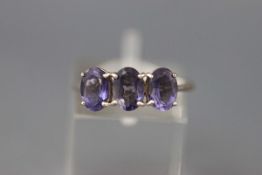 A modern 9ct white gold and oval blue iolite three stone ring, Birmingham 2009, size N, 2.