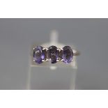 A modern 9ct white gold and oval blue iolite three stone ring, Birmingham 2009, size N, 2.