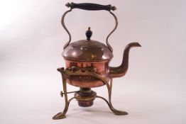 An Arts & Crafts copper kettle on brass stand with burner,
