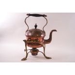 An Arts & Crafts copper kettle on brass stand with burner,