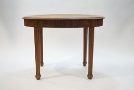 An early 20th century oval oak table with reeded detail to apron and legs, on spade feet,