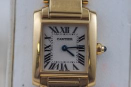 An 18 carat gold Cartier ladies watch. Champagne roman numeral dial. Quartz movement.