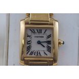 An 18 carat gold Cartier ladies watch. Champagne roman numeral dial. Quartz movement.