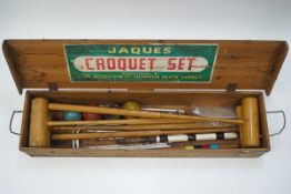 A Jacques croquet set with four mallets, four balls and metal hoops,