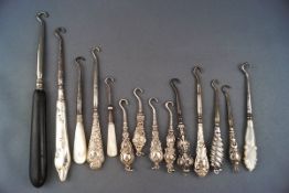 Fourteen small Victorian and later button or glove hooks,