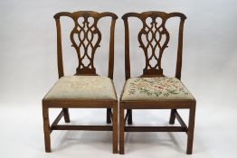 A pair of George III style mahogany dining chairs with Chippendale style carved and pierced splats,
