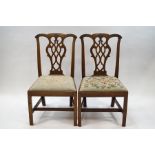 A pair of George III style mahogany dining chairs with Chippendale style carved and pierced splats,