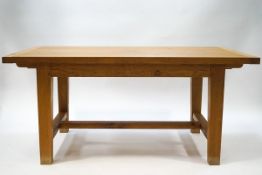 An oak extending refectory table with two loose leaves, square legs linked by 'H' stretchers,