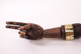 A bamboo walking stick with the handle as an articulated hand