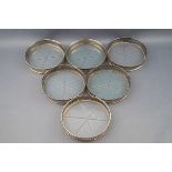 A set of six Sterling and glass bottomed small coasters,