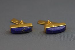 A pair of lapis lazuli domed-baton cufflinks with gilded reeded panel and chain links,