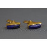 A pair of lapis lazuli domed-baton cufflinks with gilded reeded panel and chain links,