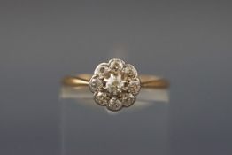 An early 20th century gold and diamond nine stone cluster ring, the old-cut stones approx. 0.