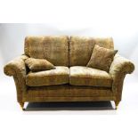 A modern Parker Knoll two seater sofa with tapestry style upholstery and cushions,