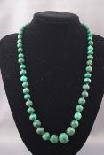 A malachite graduated off-round bead single row necklace, approx.