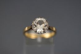 A yellow and white metal single stone ring claw set with a 10mm colourless Zircon.