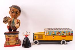 A Charley Weaver Bartender battery operated toy, an Italian biscuit tin in the form of a bus,
