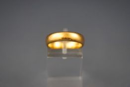 A 22 carat gold D shaped wedding ring. Hallmarked 22ct gold, Birmingham. Size: N 6.