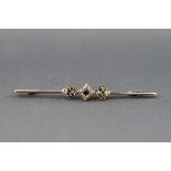 An early 20th century gold, emerald and diamond knife-edge bar brooch,