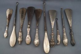 A collection of six shoe horns with silver handles together with four button hooks,