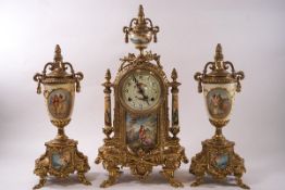 A French gilt metal mantel clock garniture, the eight day clock mounted with porcelain panels,