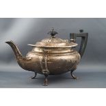 A silver small oval tea pot with a gadrooned rim, shaped corners,