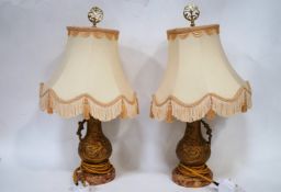 A pair of French gold painted spelter table lamps and shades,