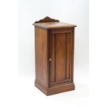 A Victorian mahogany pot cupboard, the front with carved reeded detail,