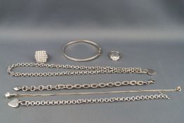 A selection of silver jewellery to include a CZ bangle, two bracelets, two necklaces and two rings.