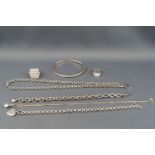 A selection of silver jewellery to include a CZ bangle, two bracelets, two necklaces and two rings.