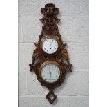 A Victorian double barometer and clock, set in an oak surround carved as foliage and a ribbon bow,